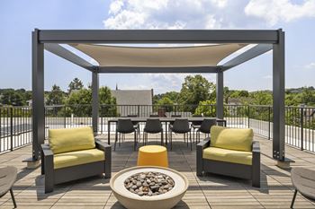 Sun-filled sky deck with pergola and fire pit